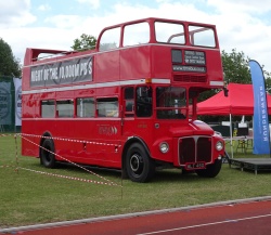 Banner advert affixed to side of open top bus - Parliament Hill Fields